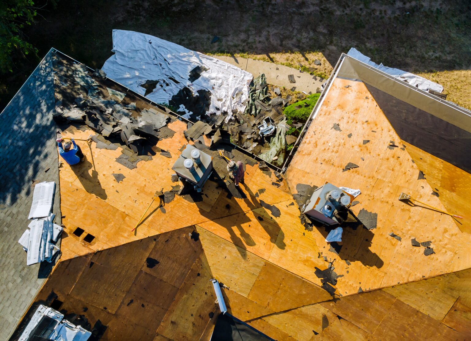 Storm-damaged roof decking during a tear-off